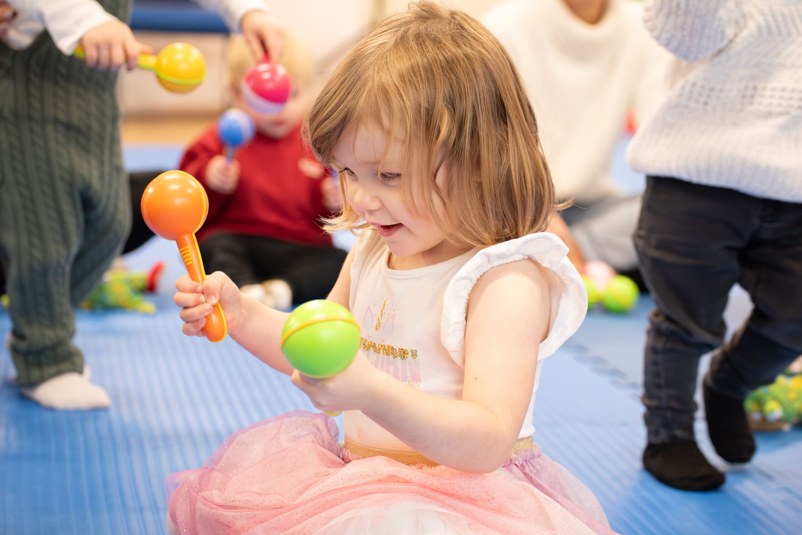 Toddler with maracas at toddler sense class
