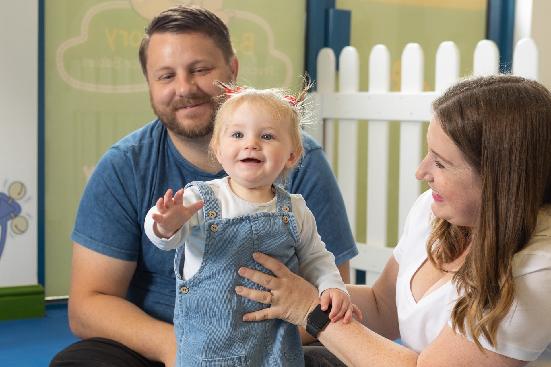 mum dad and baby at baby sensory class